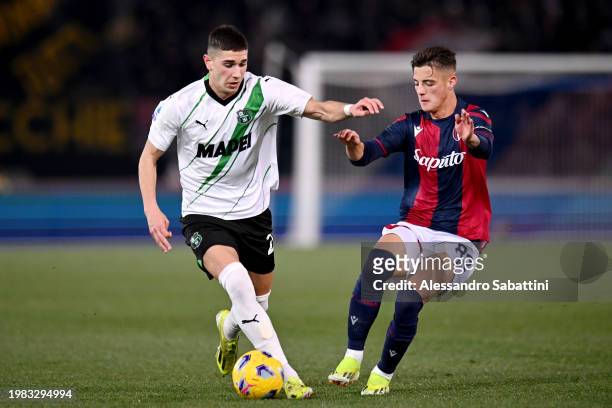 Cristian Volpato of US Sassuolo controls the ball whilst under pressure from Kacper Urbanski of Bologna FC during the Serie A TIM match between...