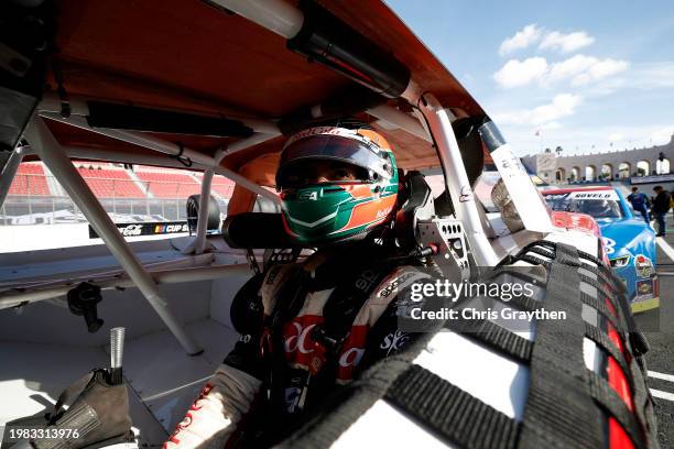 Salvador De Alba, driver of the Aga Red Cola Ford, sits in his car on the grid during practice for the NASCAR Mexico Series King Taco La Batalla en...