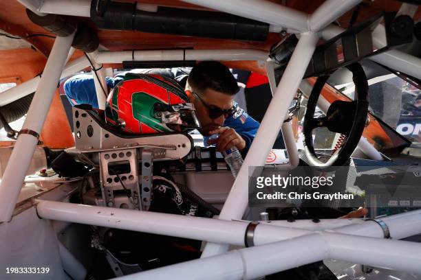 Ruben Garcia Jr., driver of the Canel's Chevrolet speaks with Salvador De Alba, driver of the Aga Red Cola Ford, in his car on the grid during...
