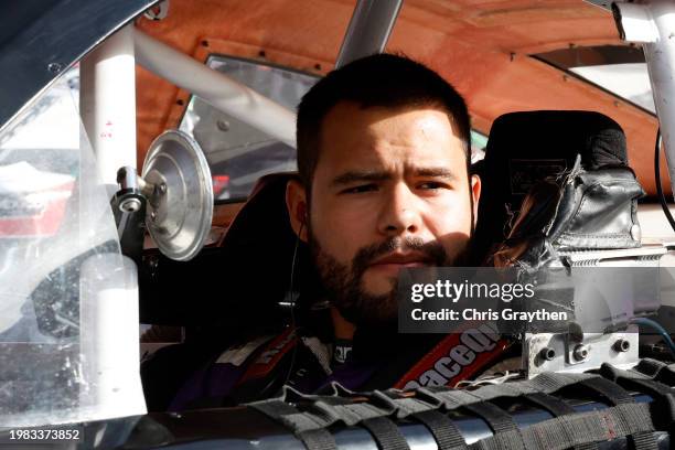 Marco Marin, driver of the Canelo Mobile Poker KPetrom Chevrolet, sits in his car during practice for the NASCAR Mexico Series King Taco La Batalla...