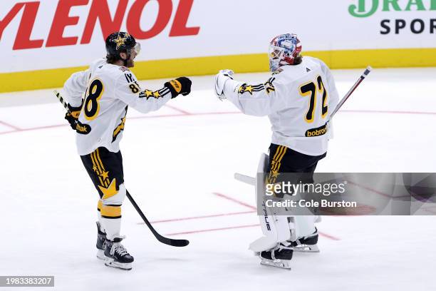 Sergei Bobrovsky of the Florida Panthers celebrates with David Pastrnak of the Boston Bruins after a win during the game between Team Mackinnon and...