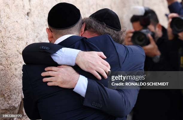 Argentina's President Javier Milei cries with Rabbi Shimon Axel Wahnish during a visit to the Western Wall, the last remaining vestige of the Second...