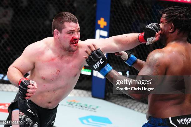 Thomas Petersen punches Jamal Pogues in a heavyweight fight during the UFC Fight Night event at UFC APEX on February 03, 2024 in Las Vegas, Nevada.