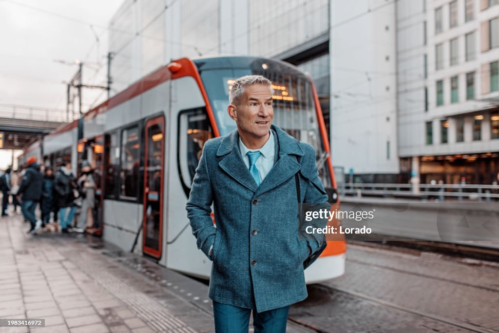 Handsome dutch businessman at a public transport hub