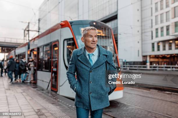 handsome dutch businessman at a public transport hub - north holland stock pictures, royalty-free photos & images