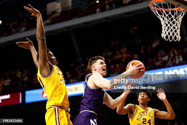 Brooks Barnhizer of the Northwestern Wildcats goes up for a shot past Pharrel Payne of the Minnesota Golden Gophers in the second half at Williams...