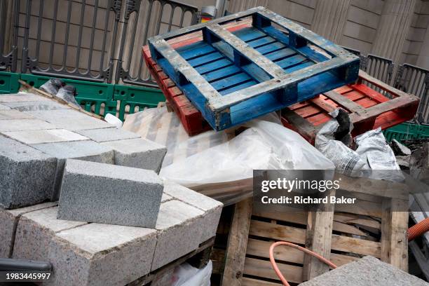 Roadworks materials and pallets are stacked behind construction fencing during the implementation of new cycles lanes beneath the walls of the Bank...