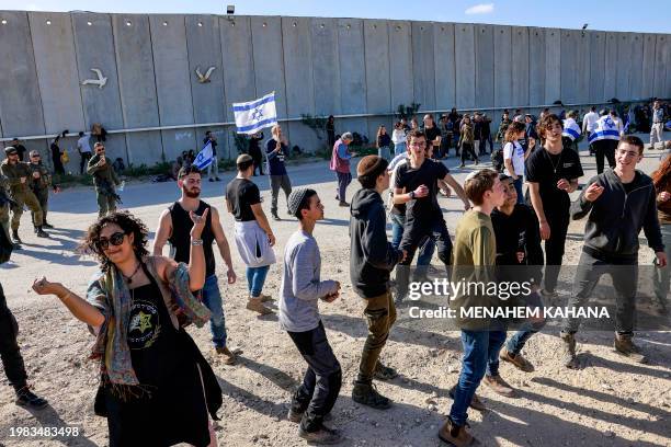 People dance as right-wing Israeli protesters gather to block the entry of humanitarian aid trucks to the Gaza Strip, on the Israeli side of the...