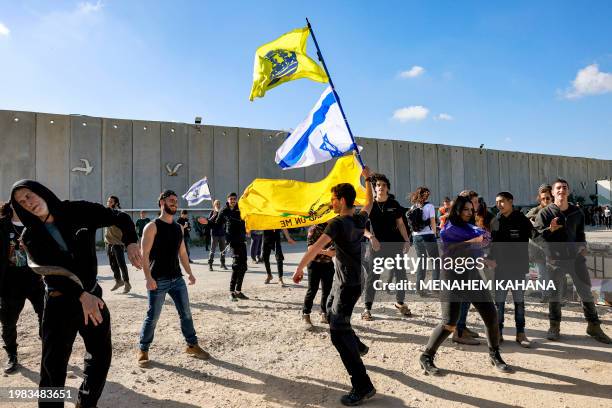 People dance as right-wing Israeli protesters gather to block the entry of humanitarian aid trucks to the Gaza Strip, on the Israeli side of the...