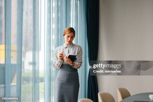 portrait of a beautiful businesswoman working on her laptop computer in the office - formal letter stock pictures, royalty-free photos & images