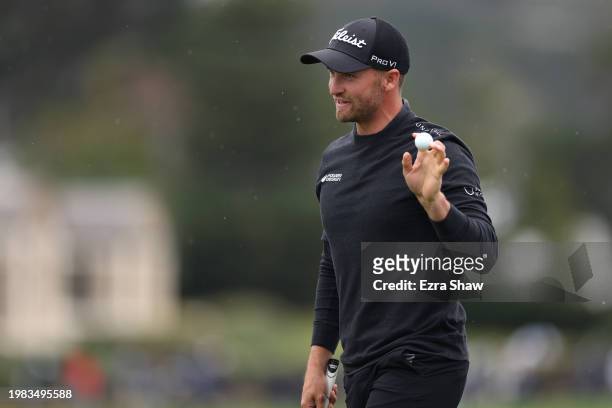 Wyndham Clark of the United States acknowledges the crowd after a putt on the 18th green during the AT&T Pebble Beach Pro-Am at Pebble Beach Golf...