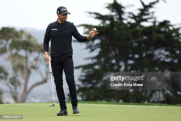 Wyndham Clark of the United States acknowledges the crowd after a putt on the 14th green during the AT&T Pebble Beach Pro-Am at Pebble Beach Golf...