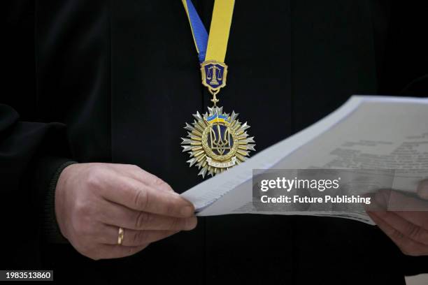 Pendant with the Ukrainian coat of arms is seen on the judge delivering the verdict in the case of former police officer Oleksandr Solovei accused of...