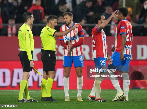 Cristhian Stuani of Girona FC speaks with referee Jesus Gil Manzano after the LaLiga EA Sports match between Girona FC and Real Sociedad at Montilivi...