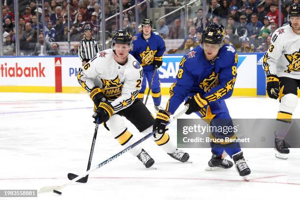 Rasmus Dahlin of the Buffalo Sabres battles for the puck with William Nylander of the Toronto Maple Leafs during the game between Team Matthews and...