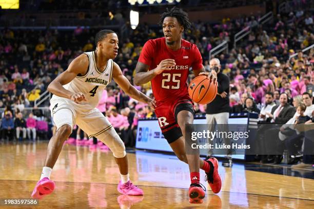 Jeremiah Williams of the Rutgers Scarlet Knights dribbles past Nimari Burnett of the Michigan Wolverines during the second half at Crisler Arena on...