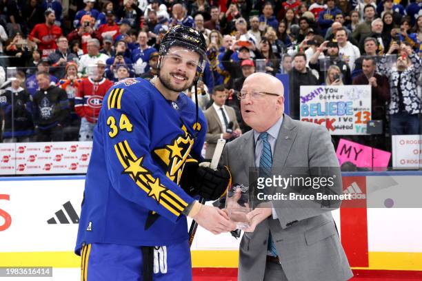 Deputy commissioner Bill Daly presents Auston Matthews of the Toronto Maple Leafs the MVP award during the game between Team Matthews and Team...