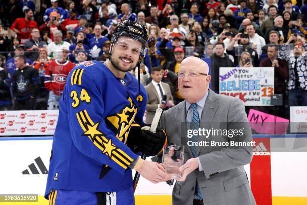 Deputy commissioner Bill Daly presents Auston Matthews of the Toronto Maple Leafs the MVP award during the game between Team Matthews and Team...