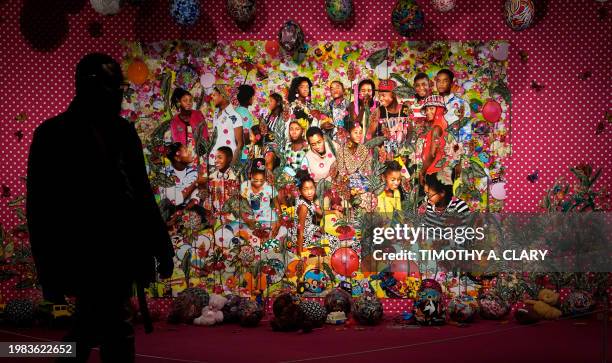 Person walks past Ebony G. Patterson's ". . . They were just hanging out you know . . . Talking about . . . ," during a press preview of the...