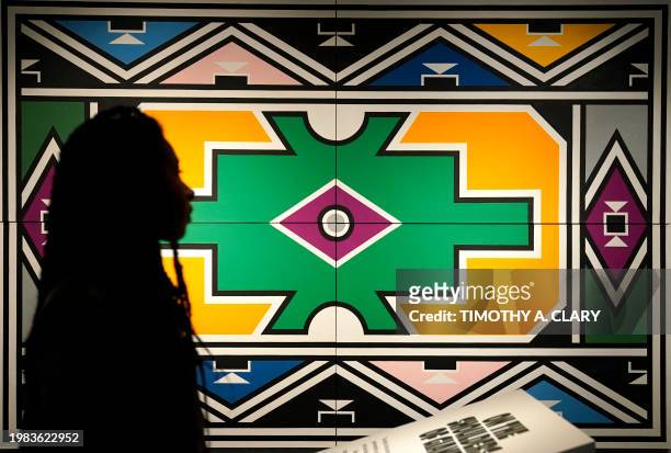 Person walks past Esther Mahlangu "Ndebele Abstract" during a press preview of the exhibition Giants Art from the Dean Collection of Swizz Beatz and...