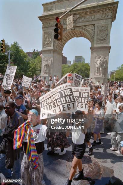 Gay marchers hold signs calling for an AIDS cure project during a Gay Pride parade and gay rights demonstration in New York, June 26, 1994. The march...