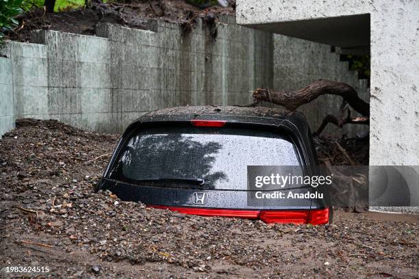 View of a van buried in mudslides at Beverly Crest neighborhood, as atmospheric river storms hit Los Angeles, California, United States on February...