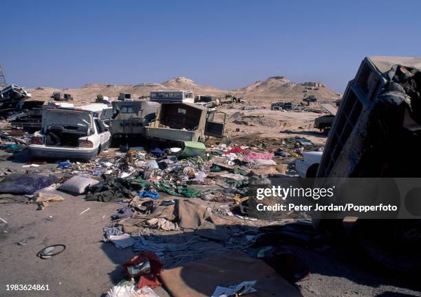 The wreckage of military transport and civilian vehicles looted on the road north from Kuwait to Iraq during Operation Desert Shield following the...