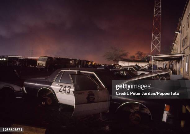 Strange daytime light over looted police cars in Kuwait City during Operation Desert Shield following the Iraqi invasion of Kuwait which led to the...