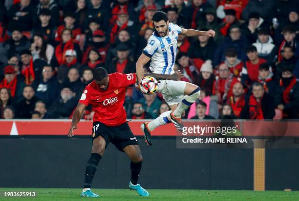 Real Sociedad's Spanish midfielder Mikel Merino vies with Real Mallorca's Canadian forward Cyle Larin during the Spanish Copa del Rey semi final...