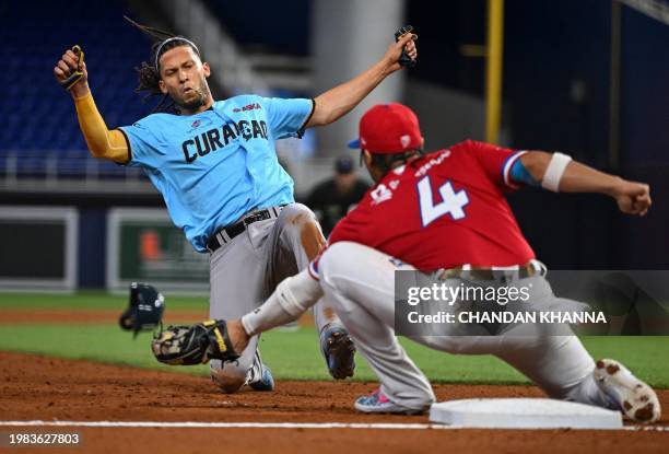 Curacao's infielder Andrelton Simmons is tagged out at third base base by Dominican infielder Gustavo Nunez during the Caribbean Series baseball game...