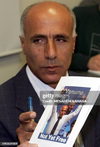 Israeli nuclear whistleblower Mordechai Vanunu holds a book with his picture on it before a press conference with Irish 1977 Nobel peace prize...