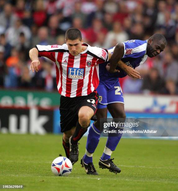 October 29: Nick Montgomery of Sheffield United and Michael Ricketts of Cardiff City challenge during the Championship match between Sheffield United...