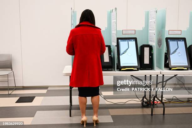 Voter prepares to cast a ballot on an electronic voting machine inside a vote center on Election Day during the Nevada 2024 presidential primary...