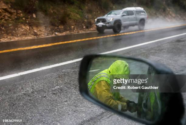 City Creek, CA, Tuesday, February 6, 2024 - Chain Installer Bill Siples at work along rte. 330 on the way to Big Bear, where chains are required...
