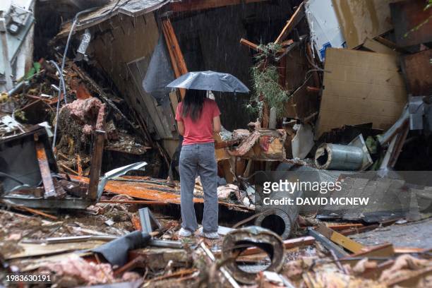 Woman stands among the wreckage of a house that was abruptly destroyed by a landslide as a historic atmospheric river storm inundates the Hollywood...