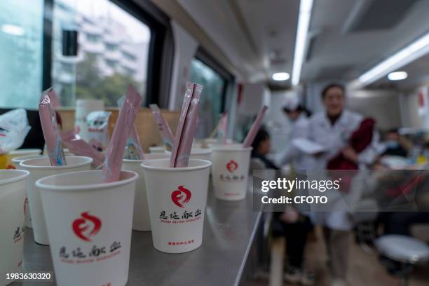 Milk powder and water cups are prepared for blood donors by blood station staff on a blood truck in Enshi, Hubei province, China, Feb 1, 2024.