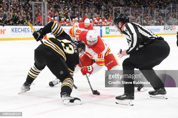 Charlie Coyle of the Boston Bruins faces off against Nazem Kadri of the Calgary Flames at the TD Garden on February 6, 2024 in Boston, Massachusetts.