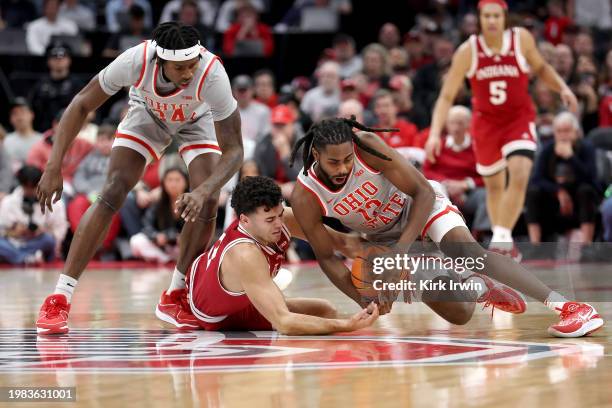 Evan Mahaffey of the Ohio State Buckeyes grabs a loose ball going to floor against Anthony Leal of the Indiana Hoosiers during the first half at...