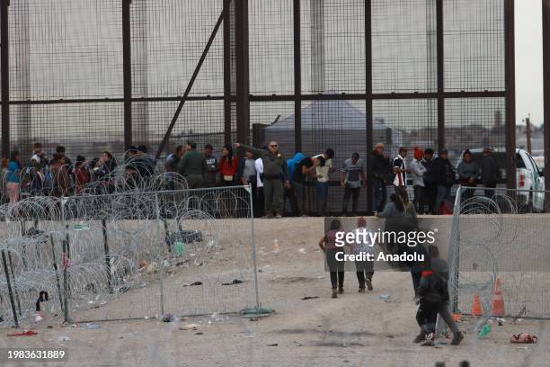 Migrants cross the border to USA through Gate 36 and to be received by elements of the Border Patrol and the Texas National Guard for the processing...