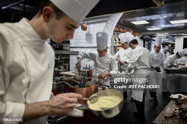 French Sous-chef Maxime Delangle works in the kitchens of the Auberge de Collonges restaurant, in Collonges au Mont d'Or on January 26, 2024. The...