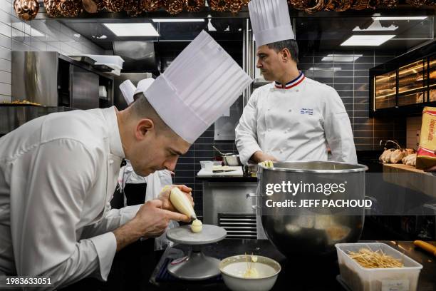 Italian chef Francesco Santin works next to French chef Oilivier Couvin in the kitchen of the Auberge de Collonges restaurant, in Collonges au Mont...