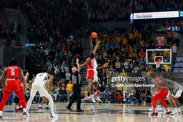 Baylor Bears center Yves Missi and Texas Tech Red Raiders forward Robert Jennings take the opening tipoff during the Big 12 college basketball game...