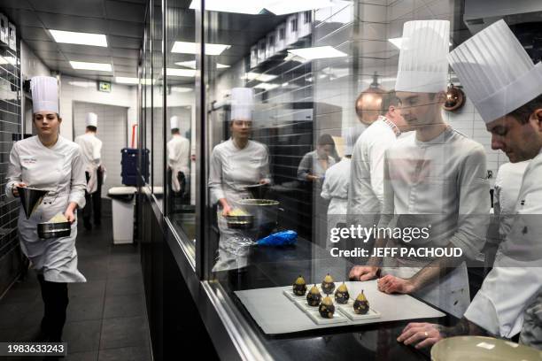 Pastry cooks work in the kitchen of the Auberge de Collonges restaurant, in Collonges au Mont d'Or on January 26, 2024. The renovated inn, overlooked...