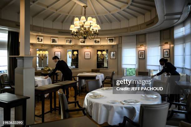 Employees prepare a room of the Auberge de Collonges restaurant, in Collonges au Mont d'Or on January 26, 2024. The renovated inn, overlooked by a...