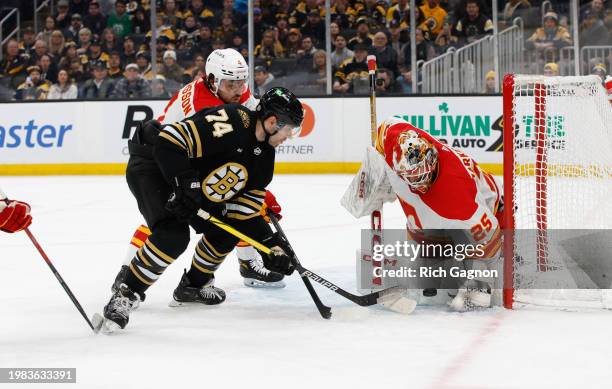 Jake DeBrusk of the Boston Bruins shoots the puck at Jacob Markstrom of the Calgary Flames during the third period the TD Garden on February 6, 2024...