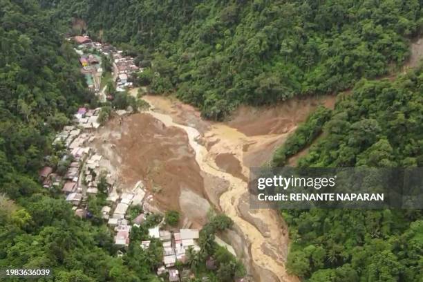 This screengrab from AFPTV aerial video footage taken on February 7, 2024 shows the site of a landslide in Davao de Oro province on Mindanao island...