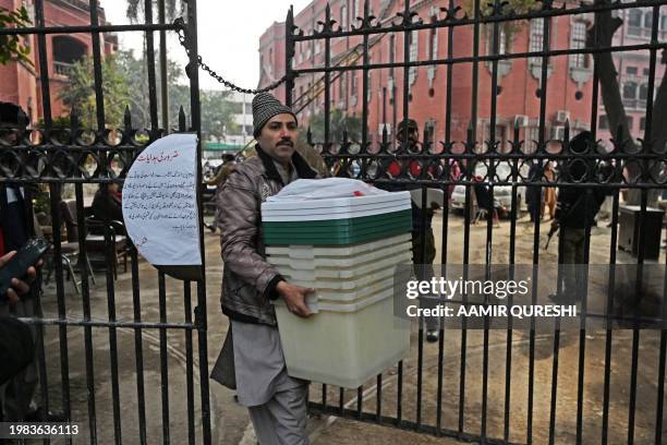 An election presiding officer leaves after collecting election materials at a distribution centre in Lahore on February 7 a day prior Pakistan's...