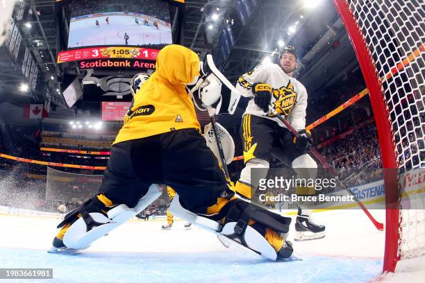 Jeremy Swayman of the Boston Bruins skates against Tomas Hertl of the San Jose Sharks during the game between Team MacKinnon and Team McDavid during...