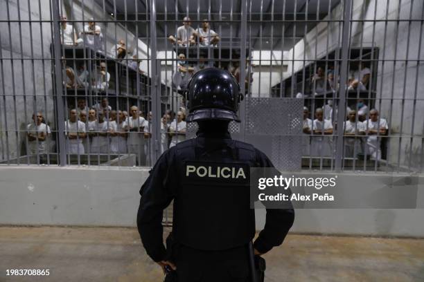 An officer in riot gear stands on patrol inside a cell at CECOT in Tecoluca on February 6, 2024 in San Vicente, El Salvador. On February of 2023 El...