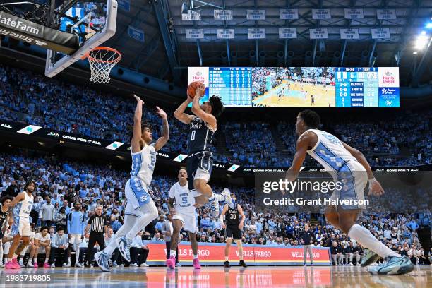 Jared McCain of the Duke Blue Devils shoots against Elliot Cadeau of the North Carolina Tar Heels during the first half of the game at the Dean E....